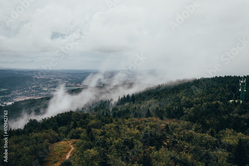 Evaporation of water from forests in northern Bohemia. Flowing fog at the top of Je  t  d. Temperature change. Strong winds cause water droplets to evaporate and mist to form. lungs of the Czech healthy