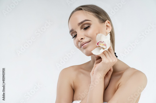 Spa treatments. Beautiful girl on a white background, she has well-groomed and clean skin. Tenderness and fragility. Place for the inscription. Beauty salon