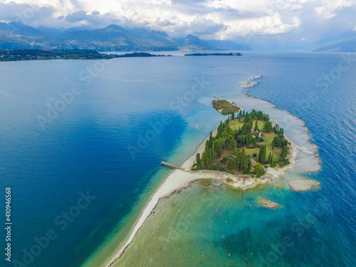 Special View by Drone - Flying on Isola dei Conigli. Moniga, Manerba in Garda Lake for an italian summer. Tourist on the lake. © Mirko