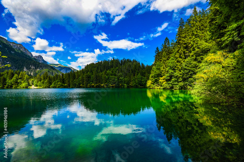 Spectacular landscape view Italian mountain lake in Dolomiti Alps, Summer Season. Tovel Lake in Trentino, Parco Adamello. Visit Trentino.