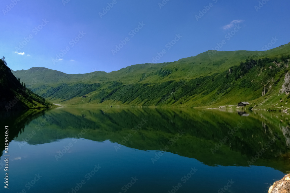 mountain lake with wonderful reflection from the mountains and blue sky