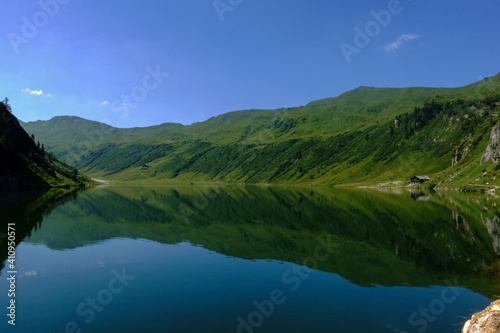 mountain lake with wonderful reflection from the mountains and blue sky