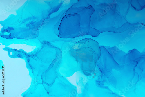 Abstract blue background, wallpaper. Mixing acrylic paints. Modern art. Marble texture. Alcohol ink colors translucent