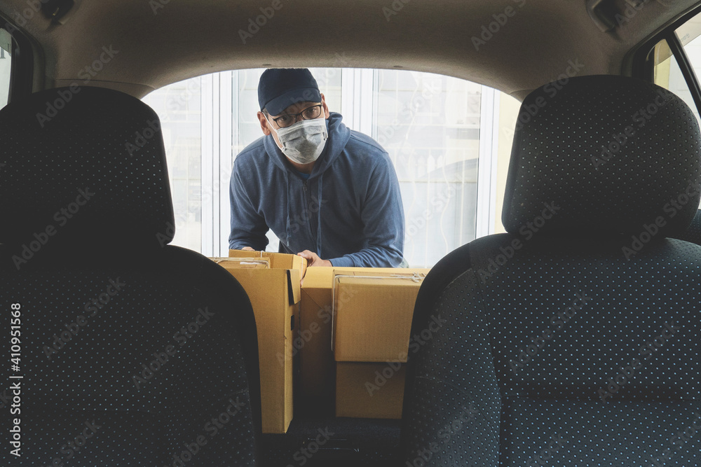 Asian man wear mask delivery online business product.E-commerce concept during covid-19 Asian man wear mask delivery online business product.E-commerce concept during covid-19