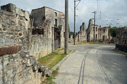 Oradour Sur Glane in France a ghost village which has been preserved as a war memorial. Tram lines, ruined buildings and empty street. Colour image. photo