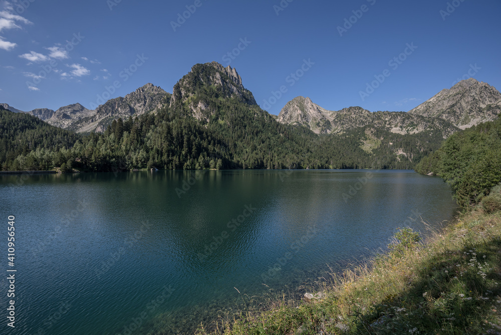 Sant Maurici Lake and Gran Encantats mountain peak as seen from the trail to Refugi d'Amitges, Aiquestortes i Estany de Sant Maurici National Park, Pyrenees, Espot village, Catalonia, Spain.