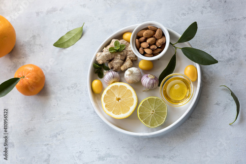 Concept of natural medicine. Natural remedies for colds on grey background. Flat lay. Copy space.
immunity booster food honey garlic ginger citrus und superfoods