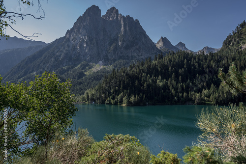 Sant Maurici Lake and Gran Encantats mountain peak as seen from the trail to Refugi d'Amitges, Aiquestortes i Estany de Sant Maurici National Park, Pyrenees, Espot village, Catalonia, Spain. photo