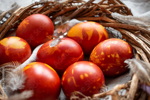 Easter Eggs Decorated with Natural Fresh Leaves and Boiled in Onions Peels on gray linen tablecloth. Happy Easter concept. Eco Easter eggs.  Zero waste Easter.