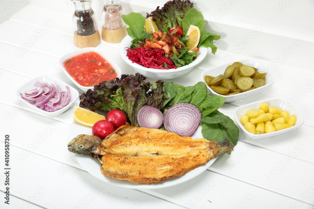 fried trout served with green salad and appetizer