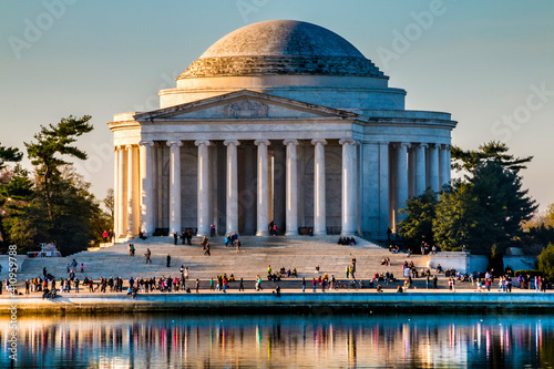 spring morning sunlight illuminating Thomas Jefferson Memorial in Washington DC with crowd of people on the steps. photo