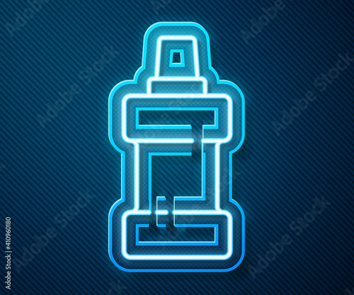 Glowing neon line Plastic bottle for laundry detergent, bleach, dishwashing liquid or another cleaning agent icon isolated on blue background. Vector.