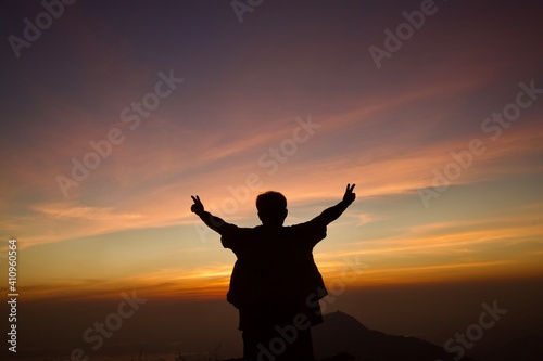 silhouette of person with arms outstretched