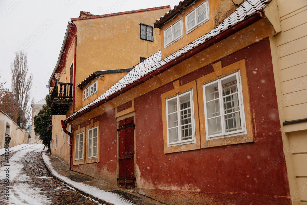 Fascinating narrow picturesque street with baroque and renaissance historical buildings, snow in winter day, Novy svet, New World in vicinity of Hradcany, Prague, Czech Republic