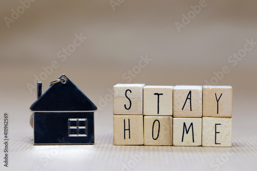 Stay home written with wooden cubes and miniature house, Covid-19, health stay at home. Quarantine concept. background copy space