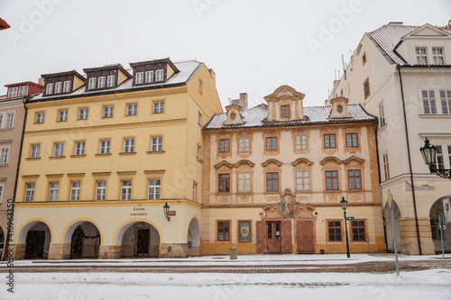 Baroque house with painted windows at Loreto Square, national cultural landmark, Hradcany under snow in winter day, Prague, Czech Republic