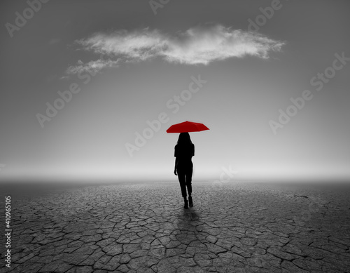 silhouette of person with red umbrella of backdrop in black and white gradation
