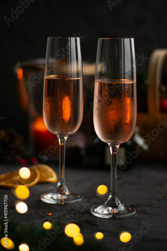 Glasses of rose champagne on blurred dark backgrounde, bokeh . Celebration concept. New year. Valentines day.