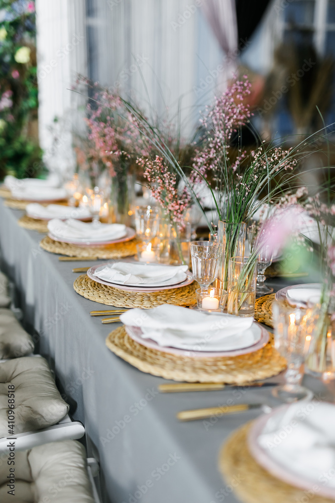 Fototapeta premium decorated with fresh flowers and served table for a festive dinner indoors