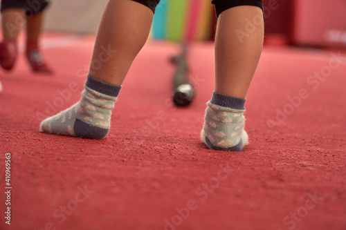 Girl gymnast goes in for sports. Red mats in the gym. High quality photo