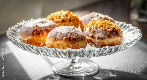  fresh baked donuts with nuts on a epergne (plate) photo