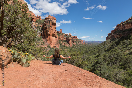 Woman Practicing Yoga in the Red Rocks of Sedona Arizona photo