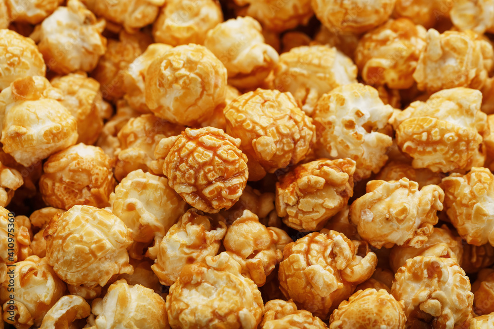 Caramel popcorn close-up as a background, full-screen texture. Caramel popcorn close-up as a background, full-screen texture.
