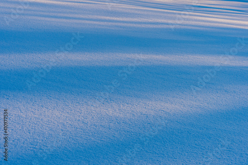 Winter light on the snow of a field.