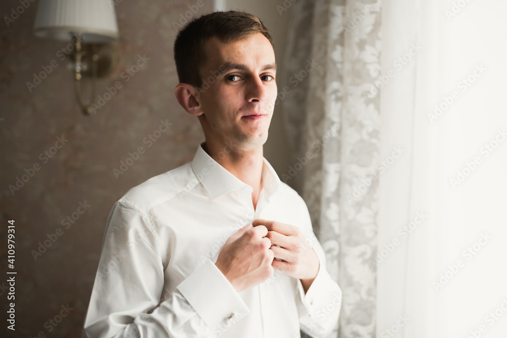 Beautiful man, groom posing and preparing for wedding Beautiful man, groom posing and preparing for wedding