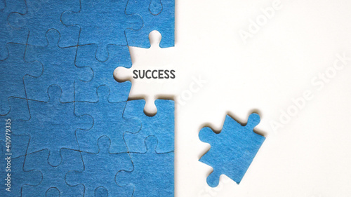 Top view flat lay of jigsaw puzzle with one piece missing .Concept of absence and incomplete.Putting the last piece . Teamwork and success concept