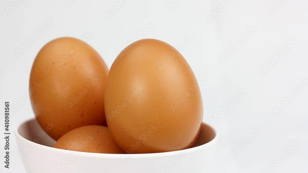 Chicken egg rotates on a white background. Close-up of an egg Chicken egg rotates on a white background. Close-up of an egg