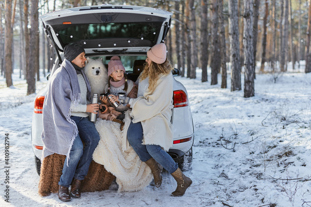 Happy family with dog on vacation during the winter holidays