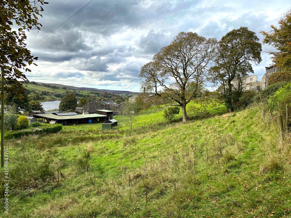 Looking over, outbuildings and farms, with Leeming Reservoir in the distance in, Leeming, Keighley, UK
