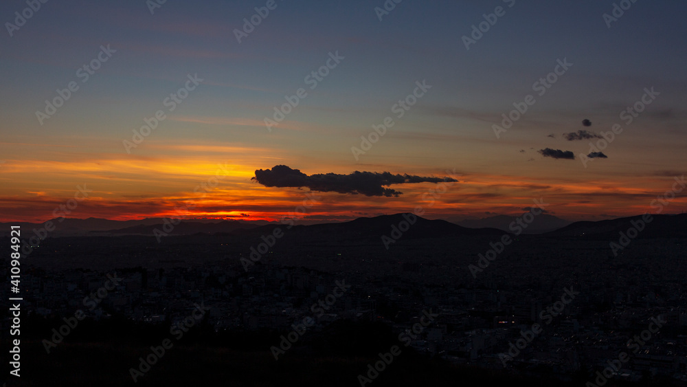 Sunset in Athens city with dog shape in the clouds