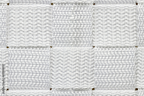 Abstract alternating horizontal and vertical pattern made up of squares of woven white nylon.