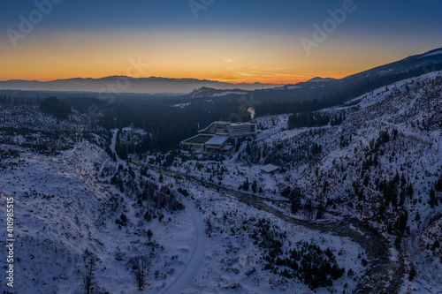 snowy valley with river and road after sunset with Permon