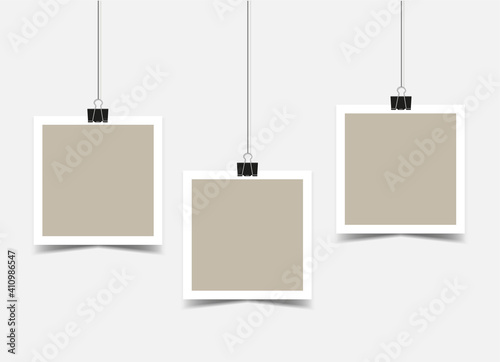 Three empty Square photo frames with border hanging on binder clips. beige photo cards on ropes with a shadow. Mockup. Vector 3d realistic. blank template. EPS10.