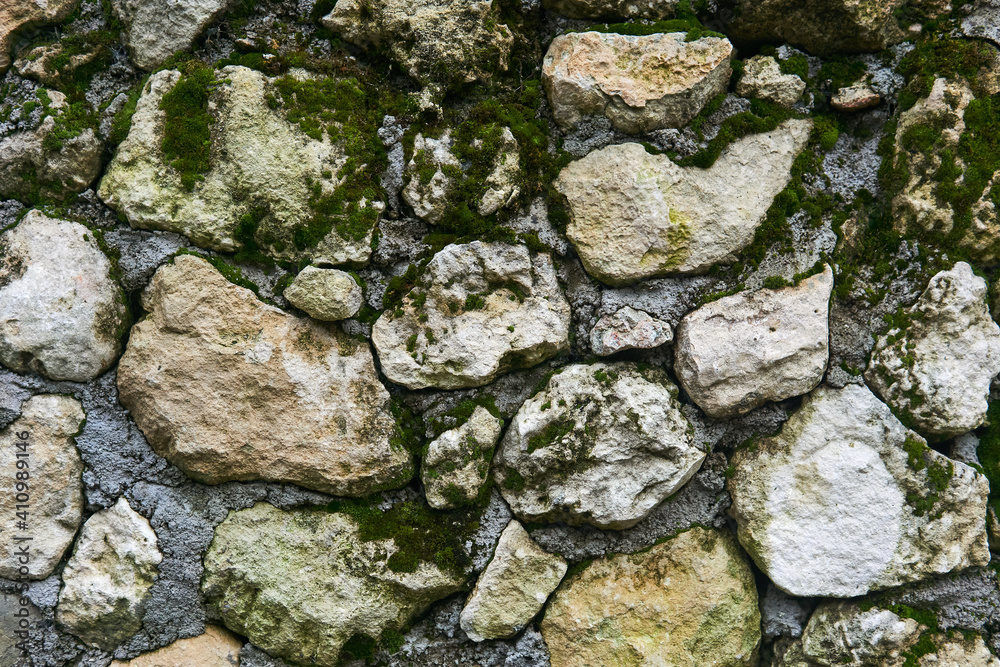 background, texture - mossy rough masonry from natural stone