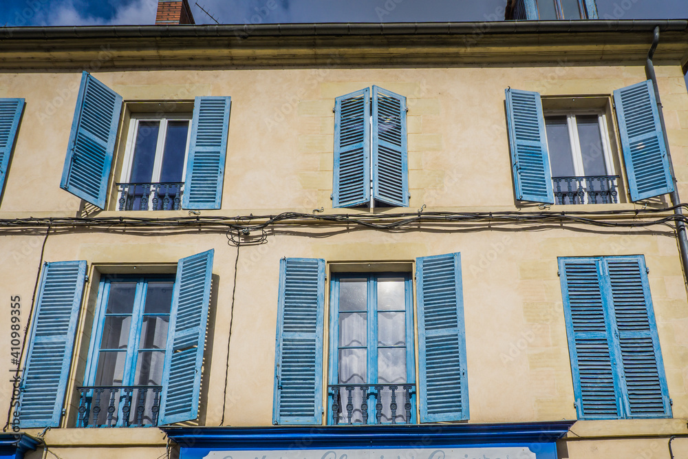 Cute townhouse facade with blue shutters in the historic center of Nevers, located in Burgundy, France