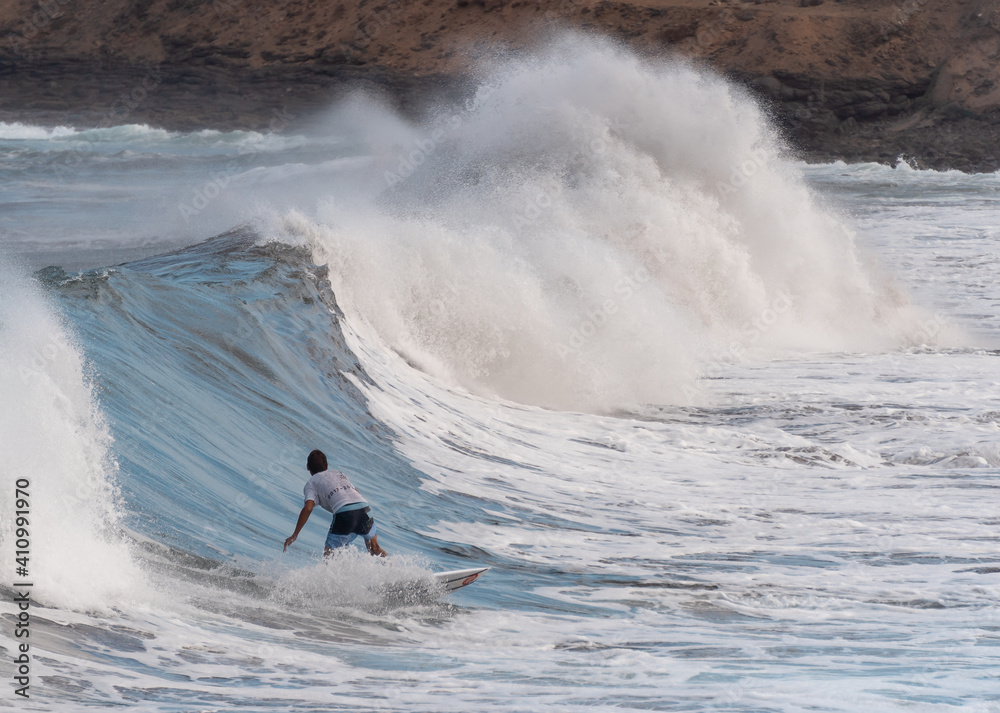 young surfer rides a wave in Gran Canaria. Canary Islands young surfer rides a wave in Gran Canaria. Canary Islands