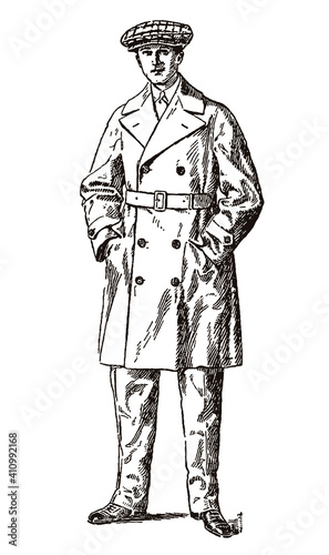Standing man from the early 20th century wearing antique motorcycle clothing