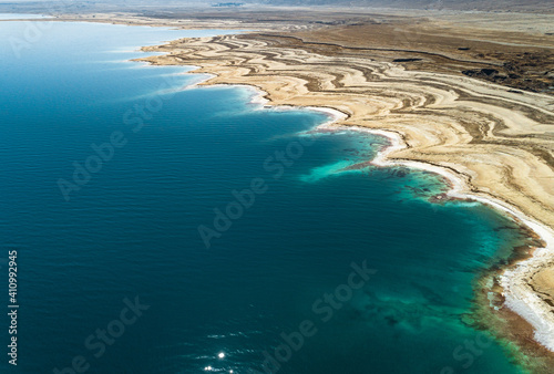 Aerial view of the texturized expanding shoreline in the Dead sea as the water level decreases. Negev, Israel.