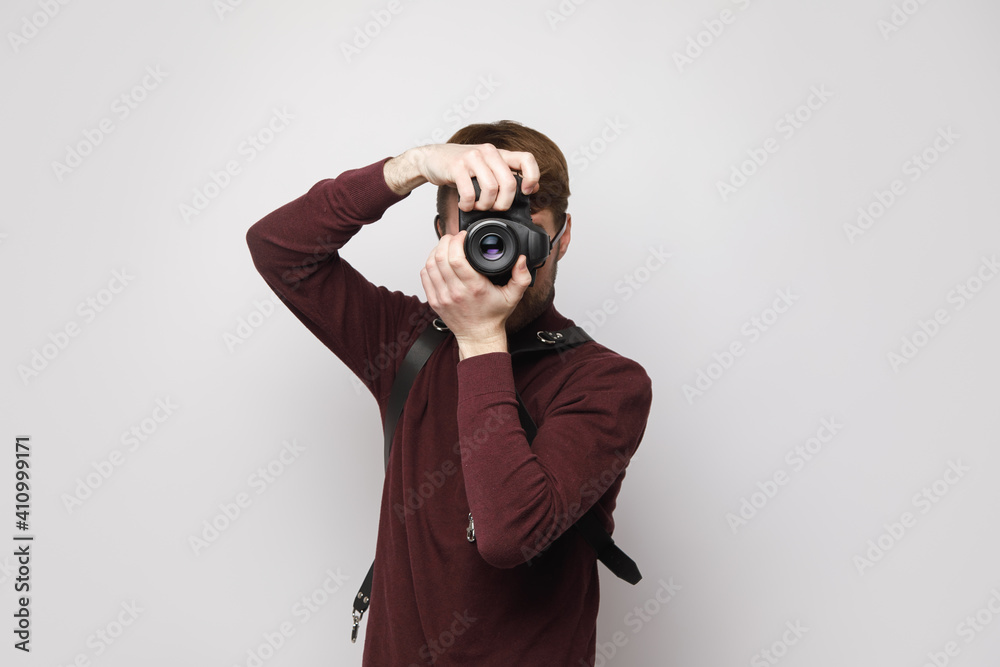 Photographer with a camera on a light background, photography training Photographer with a camera on a light background, photography training