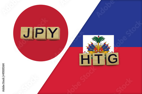 Japan and Haiti currencies codes on national flags background photo