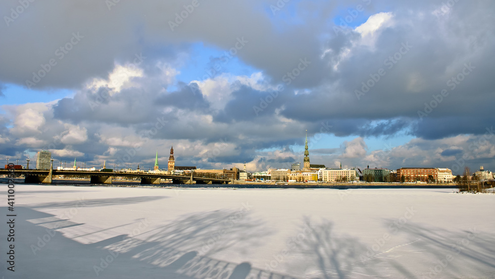 riga, city panorama, frozen river and snow in the foreground
