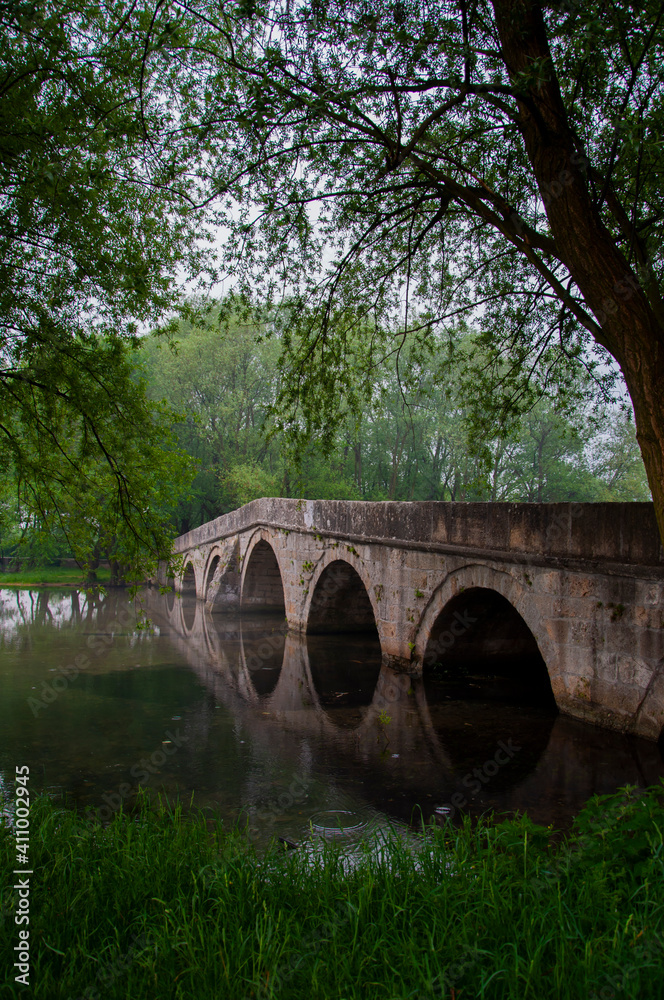 Fototapeta premium Roman bridge reflection on river Bosna in Sarajevo