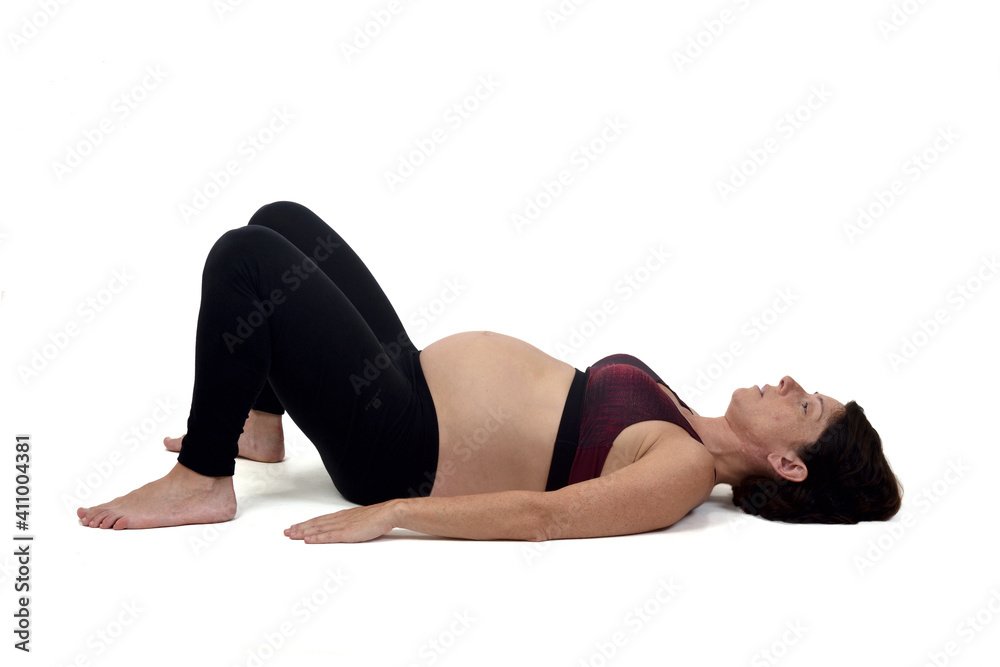 pregnant woman doing floor exercises on white backgroun, pregnant woman doing floor exercises on white backgroun,