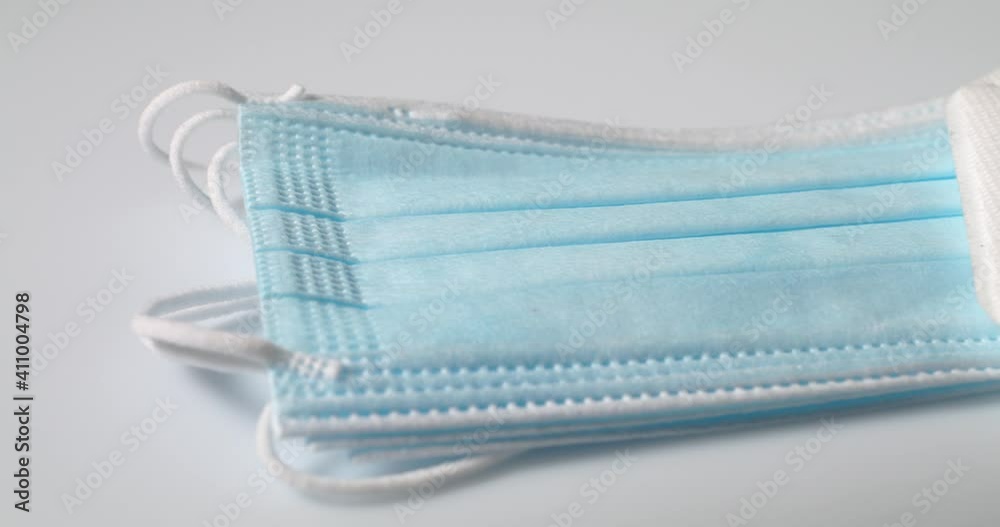 Blue Clinical Mask and N95 FFP2 Mask on White surface, isolated. Protection from airborne disease. Protection from Covid, Flu and other Air Diseases Blue Clinical Mask and N95 FFP2 Mask on White surface, isolated. Protection from airborne disease. Protection from Covid, Flu and other Air Diseases