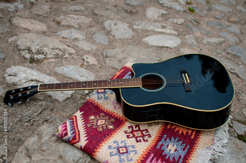 Guitar laying on oriental rug on the Roman Bridge in Sarajevo