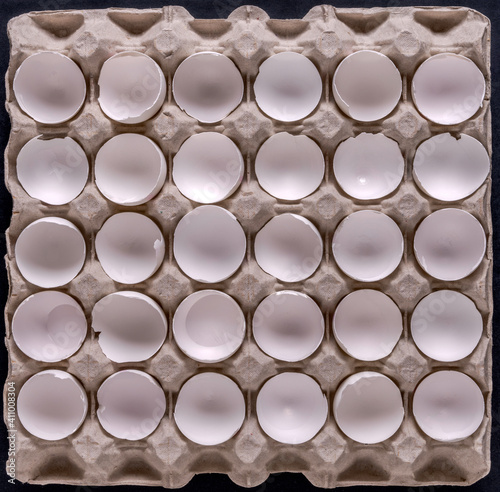 A full tray of empty white egg shells as a background